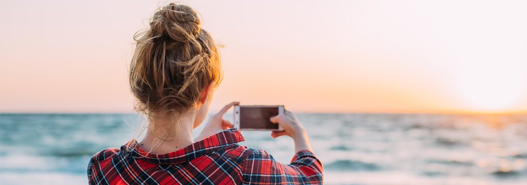 Woman takes landscape photo