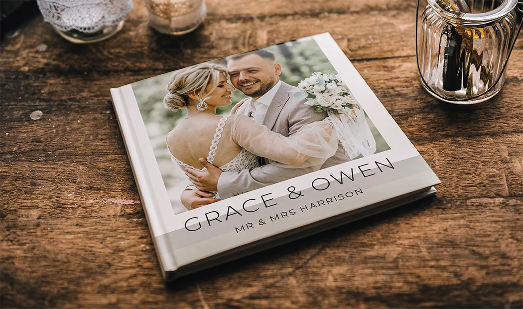 Custom printed Printerpix photo album with hard cover and large photos of young couple