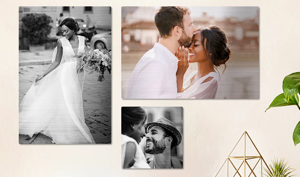 Three personalized brushed-metal prints showcase romantic couples, one bride, and a tender kiss, creating a unique, cherished home gallery.