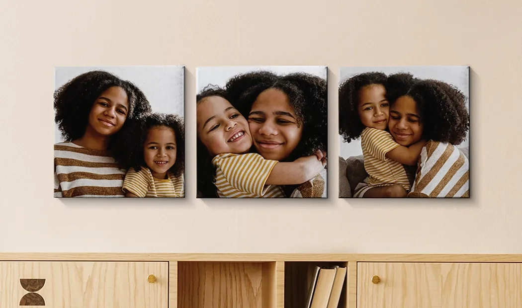 Photo Canvas Display Panels|Canvas Panels|Man and woman putting up a photo canvas with a holiday photo on|Woman putting up three black and white family photo canvases|Mom and four young kids sitting on sofa in front of four photo canvases|Couple in front of blue wall with nine square photo canvases on|||||
