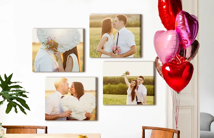 Photo Canvas Display Panels|Six Printerpix square photo canvases on a lounge wall with family and child photos on|Man and woman putting up a photo canvas with a holiday photo on|Woman putting up three black and white family photo canvases|Mom and four young kids sitting on sofa in front of four photo canvases|Couple in front of blue wall with nine square photo canvases on|||||