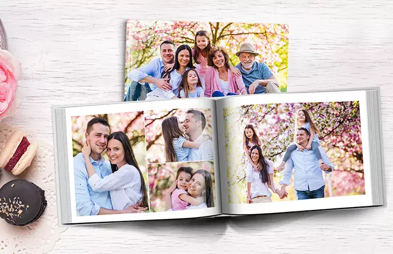 Hardcover Custom Photo Book|Custom printed Printerpix photo album with hard cover and large photos of young couple|Printed personalized photo book with pictures of mother and son and photo cover|Holiday photo album with custom photo printed cover|Personalized photo book printed with pictures of the football team and the photo cover|Family photo album with custom printed cover and family name text|||||