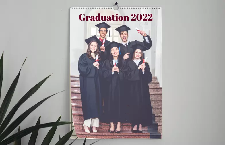 wall 2020 custom photo calendar by Printerpix|Graduation photo on custom wall calendar hung up in living room|Woman writing on A4 customised wall calendar by printerpix with christmas theme photo|A3 2020 wall calendar hung up with personalised photo design by printerpix|Romantic couple in living room with personalised 2020 wall calendar with proposal photo|Dog photos on custom design photo calendar hung up on wall|||||