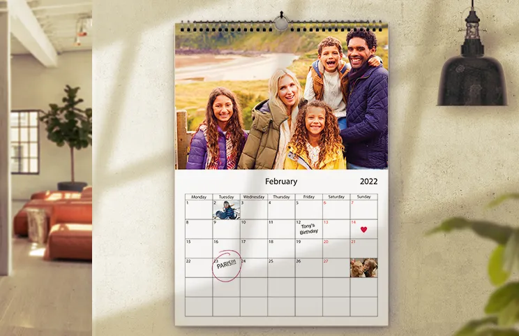 wall 2020 custom photo calendar by Printerpix|Girlfriend photo on custom wall calendar hung up in living room|Woman writing on A4 customised wall calendar by printerpix with christmas theme photo|A3 2020 wall calendar hung up with personalised photo design by printerpix|Romantic couple in living room with personalised 2020 wall calendar with proposal photo|Dog photos on custom design photo calendar hung up on wall|||||