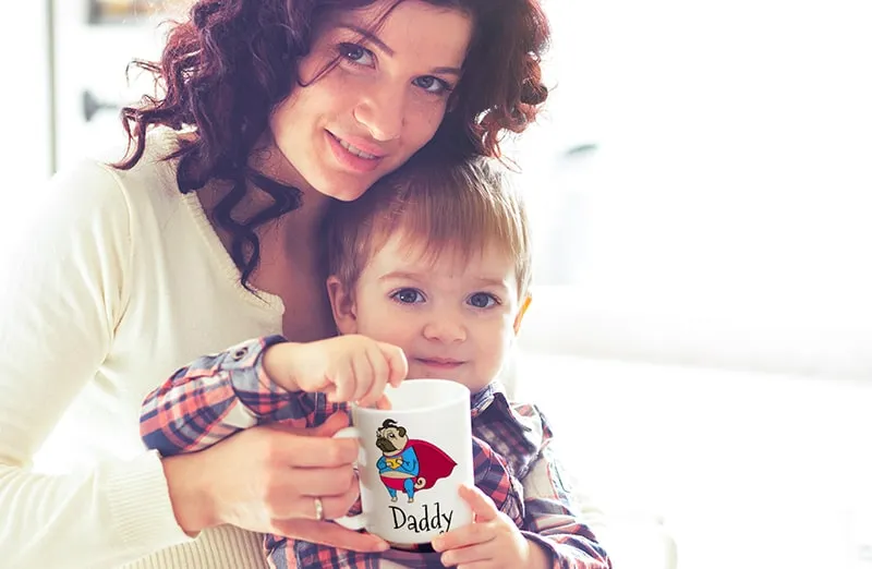 Mum and baby holding Printerpix cartoon design custom mug with dad text
