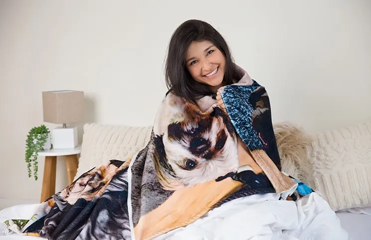 Large custom mink touch blanket on double bed with picture collage of family photos