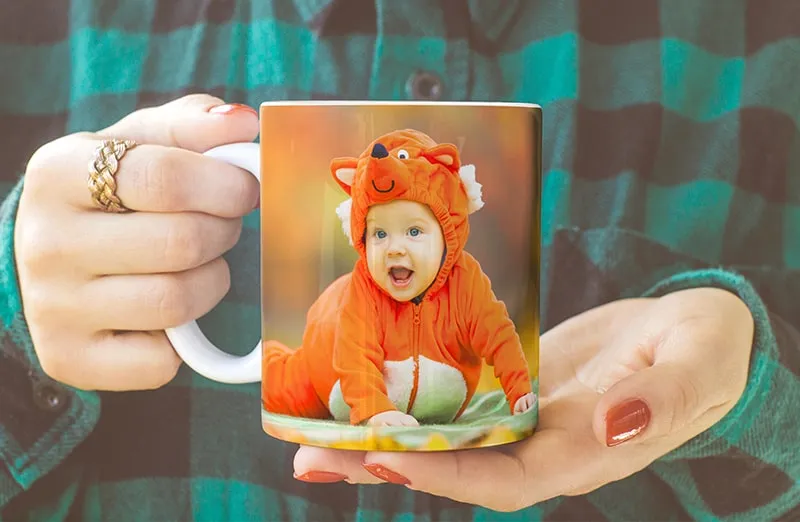 Personalised photo mug with picture of baby crawling wearing animal overall
