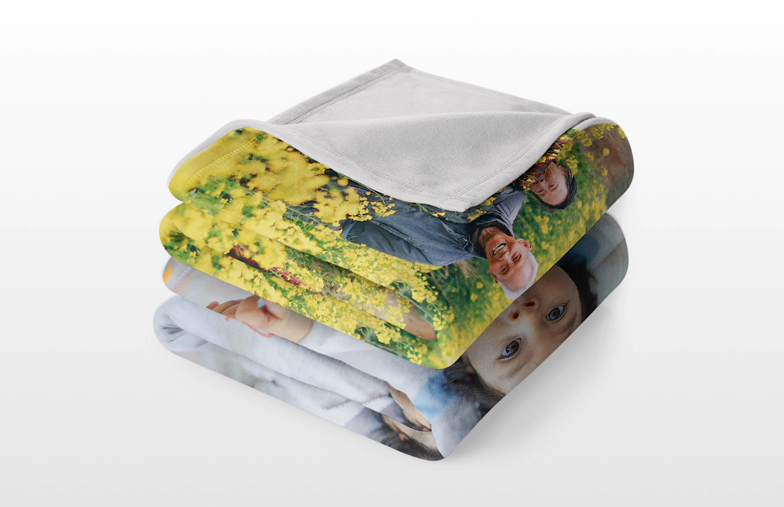Custom fleece blanket on a bed with family photo