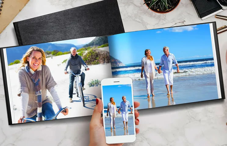 Couple look at leather cover custom photo book made by Printerpix