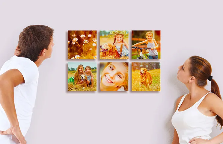 Man and woman looking at six photo tile prints with pictures of kids on