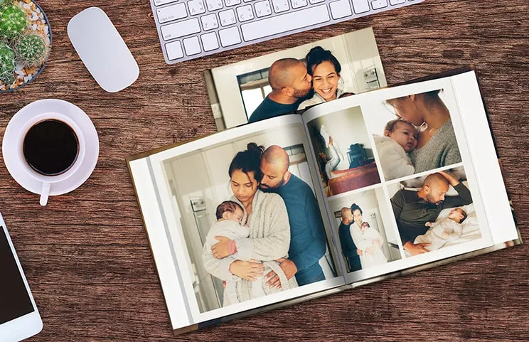 Two people looking at custom photo book with wedding photos and bride