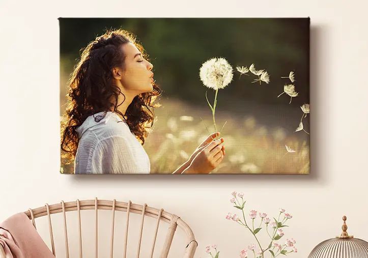 portrait of a girl on canvas print holding a flower and blowing at it
