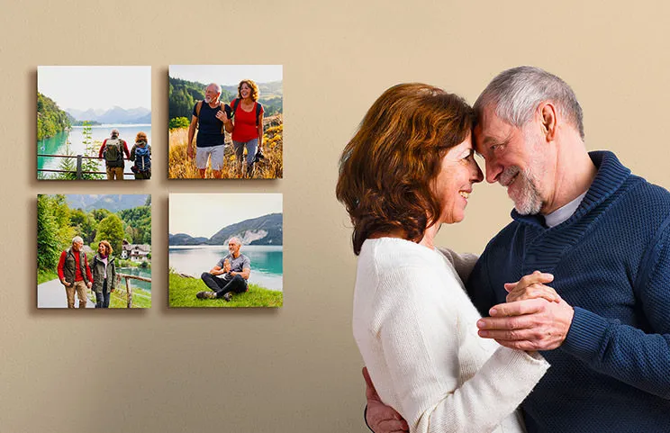 Married couple cuddling in front of four photo prints of them on holiday